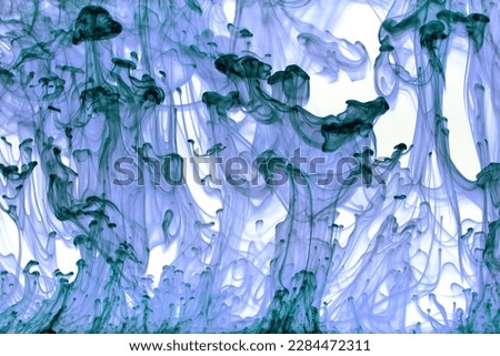 Abstract background picture with blue paint dissolving in water