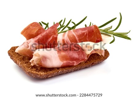 Traditional Spanish Jamon Serrano ham, Prosciutto Crudo, Parma ham, Italian antipasto, isolated on white background Royalty-Free Stock Photo #2284475729
