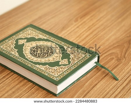 A holy Koran or holy Book. Kitab Suci Al-Quran. with negative space or copy space. photo illustration of moslem activity reading holy Koran. English translation : "The Holy Koran". 