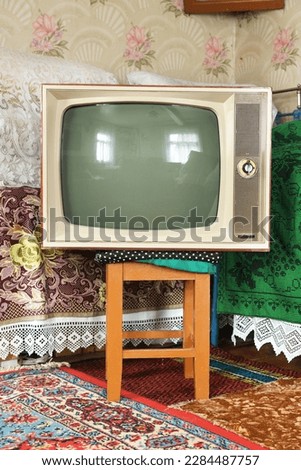 Old vintage TV in a rustic interior. Royalty-Free Stock Photo #2284487757