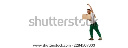 Young man emotionally shouting at strike, protesting with cardboard tablets isolated over white background. Concept of human rights, freedom and equality, political issues. Banner. Copy space for ad