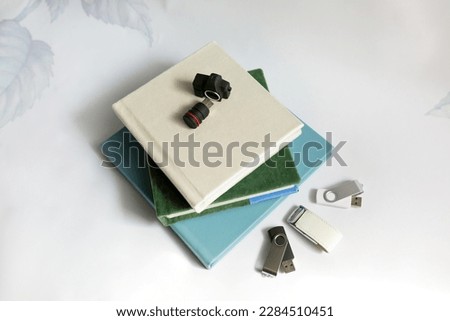 stack of photobooks with usb flash cards on white background