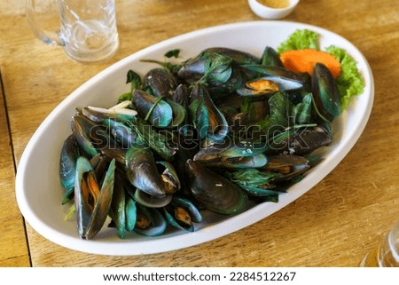 cooked boiled black mussels on wooden table. High quality photo