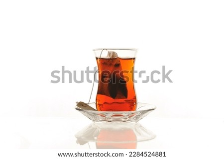 tea bag brewing in a classic Turkish tea glass