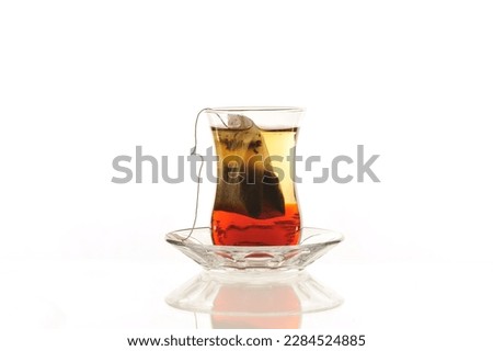 tea bag brewing in a classic Turkish tea glass