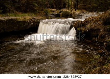 River with small waterfall in natural light, nature photo Royalty-Free Stock Photo #2284528937