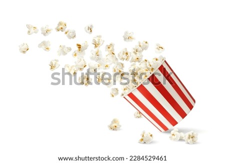 Flying popcorn flakes and bucket, cinema and movie theater snack food container. Vector realistic paper box, bag or cup with pattern of white and red stripes. 3d large bucket full of tasty popcorn Royalty-Free Stock Photo #2284529461