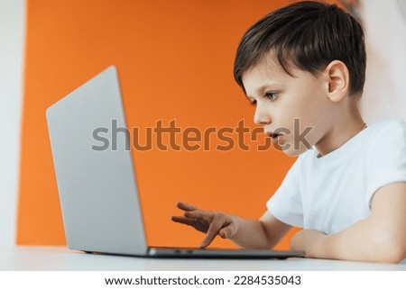an education online online games boy sits at the computer in the office
