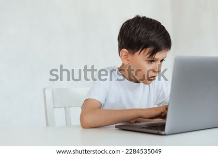 education online online games classes boy sitting at laptop at school