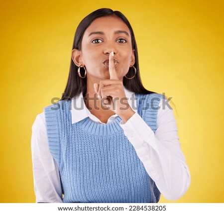 Portrait, secret and woman with finger on lips, private and whisper on a studio background. Face, female person or girl with gesture for quiet, silence and secrecy with privacy sign, gossip and emoji