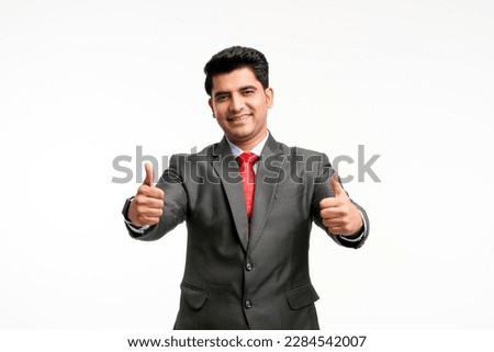Young indian businessman showing thumps up. Royalty-Free Stock Photo #2284542007