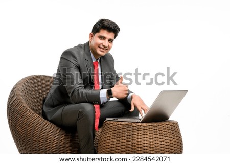 Young businessman using laptop and showing thumps up on white background. Royalty-Free Stock Photo #2284542071