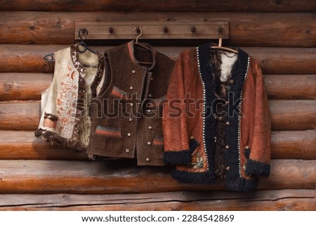 antique, vintage clothes of ancient shepherds against the background of a wooden wall. Royalty-Free Stock Photo #2284542869