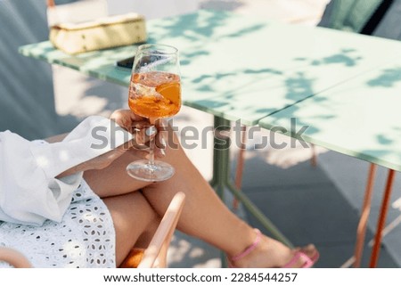 Woman drinking iced summer cocktail aperol spritz Royalty-Free Stock Photo #2284544257