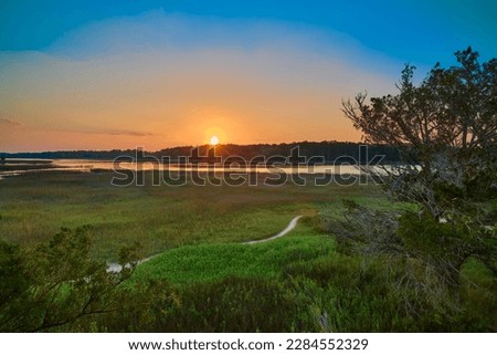 Sunset viewed from the observation tower at Skidaway Island State Park, GA. Royalty-Free Stock Photo #2284552329