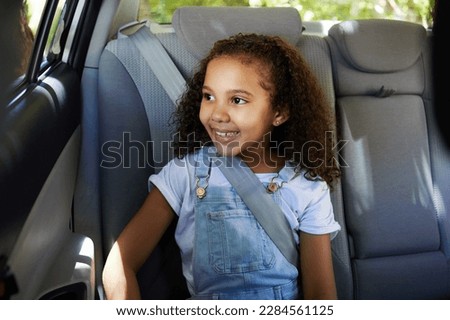 Road trip, girl child and happy in car backseat for travel, journey and drive, happy and relax. Smile, kid and little passenger enjoying drive in vehicle for adventure, vacation or weekend traveling Royalty-Free Stock Photo #2284561125