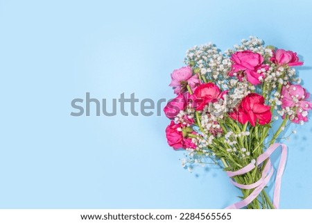 Simple spring holiday greeting card background with bouquet of beautiful ranunculus flowers. Gift for holiday, birthday, Wedding, Mother's Day, Valentine's day, Women's Day. Floral arrangement flatlay