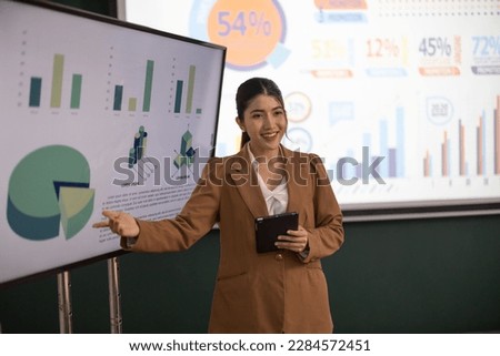 Female financial advisors on create a detailed budget for the company and present it to investors and upper management, outlining ongoing cash demands, revenue deficits, and sources of finances. Royalty-Free Stock Photo #2284572451