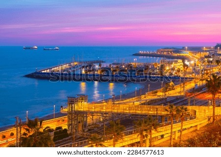 Tarragona Illuminated train station . Illuminated harbor and railroad of Tarragona Catalonia Spain