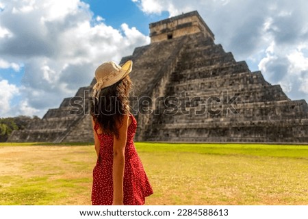 Beautiful tourist observing the old pyramid and temple of the castle of the Mayan architecture known as Chichen Itza these are the ruins of this ancient pre-columbian civilization and part of humanity Royalty-Free Stock Photo #2284588613
