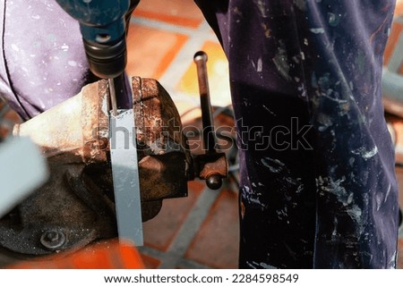 Image of Metalworker working on a drilling machine

