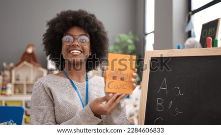 African american woman preschool teacher having vocabulary lesson at kindergarten