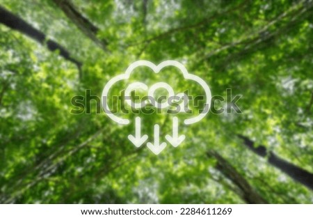 Reduce CO2 emissions to limit climate change and global warming. Low greenhouse gas levels, decarbonize, net zero carbon dioxide footprint. green background. Royalty-Free Stock Photo #2284611269
