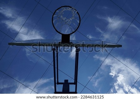 Basketball hoop, red ring and net, blue sky background, underview. empty basket. basketball net. summer playground. 