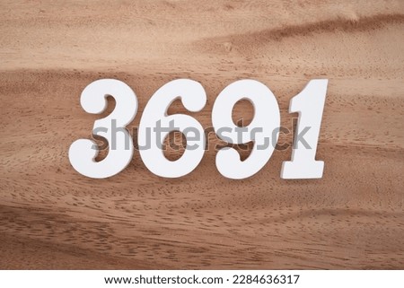 White number 3691 on a brown and light brown wooden background.