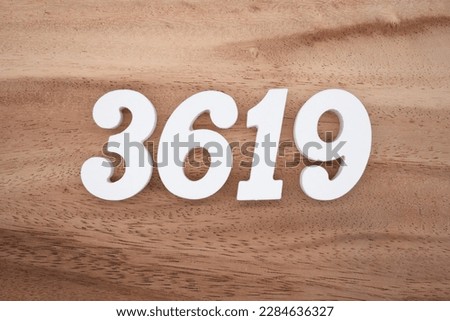White number 3619 on a brown and light brown wooden background.