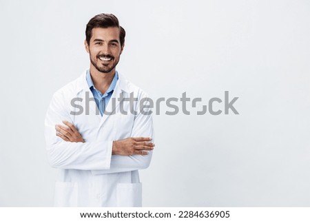 Man doctor in a white coat with a stethoscope smile with teeth and good test results looking into the camera on a white isolated background, copy space, space for text, health Royalty-Free Stock Photo #2284636905