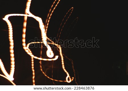 Night photography of neon and head lights with motion blur.                  