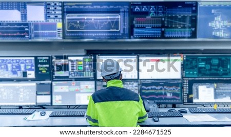 Engineer working at control room,Manager control system,Technician man monitoring program from a lot of monitor Royalty-Free Stock Photo #2284671525