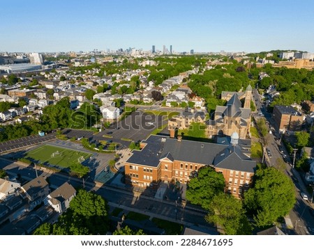 Brighton historic center including St. Elizabeth's Medical Center and St Columbkille's Parish church aerial view with Boston Back Bay skyline at the background in Boston, Massachusetts MA, USA. 