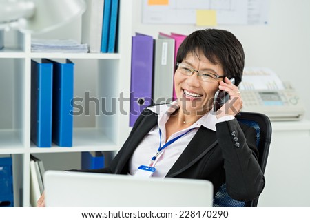 Positive businesswoman talking on the phone