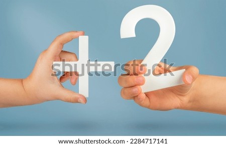 Plus two. Plus size concept. Age limit of two years to view content. White number 2 with a plus in hand on a blue background close-up.