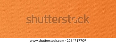 Top view of orange woven cotton smooth fabric texture background. Bright orange cloth backdrop for design art work