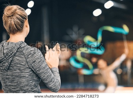 Coaching, gymnastics and clapping with woman in stadium for training, fitness and teaching. Celebration, sports and workout practice with coach and acrobat for performance, flexibility and show