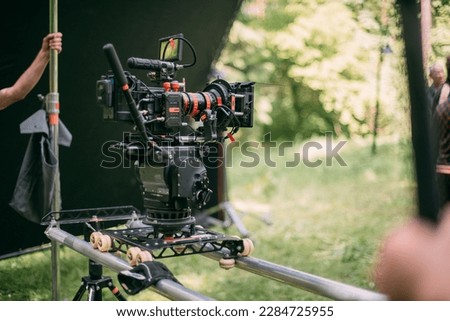 Professional cinema and video camera on the set. Shooting shift, lighting fixtures, shooting equipment and the team. Technique of modern filming and advertising. Royalty-Free Stock Photo #2284725955