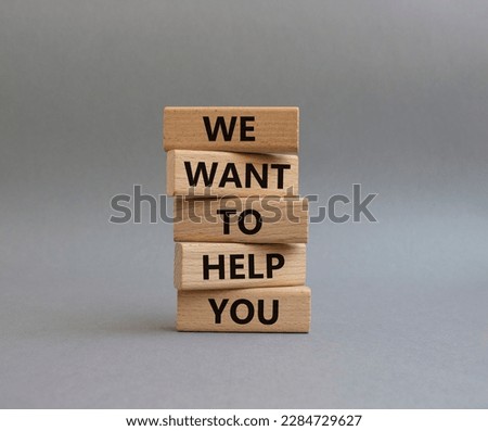 We want to help you symbol. Wooden blocks with words We want to help you. Beautiful grey background. Business and We want to help you concept. Copy space.
