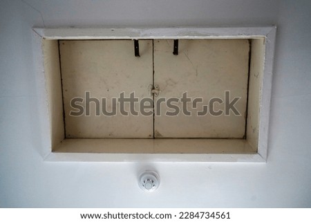Close up of a loft hatch in a ceiling Royalty-Free Stock Photo #2284734561
