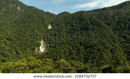 A waterfall between the mountains captured by a drone in Brazil.