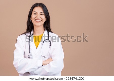 Caucasian female doctor smiling at the camera with arms crossed