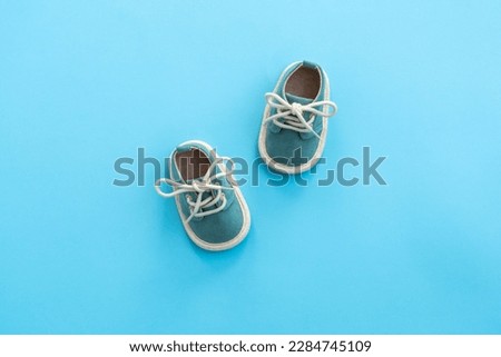 Baby shoes on paper background with copy space. Baby clothes concept. Top view, flat lay Royalty-Free Stock Photo #2284745109