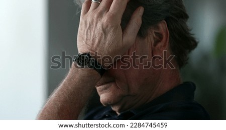 Tired older man yawning and rubbing face with hands. Pensive senior person feeling exhausted Royalty-Free Stock Photo #2284745459