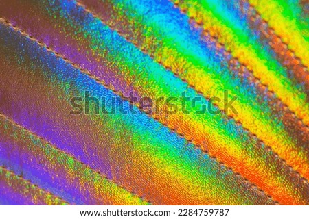 Playing surface of an artificial shell shaped bag. Metallic texture with gradual color changing. Rainbow gradient. Color transition. Visible spectrum