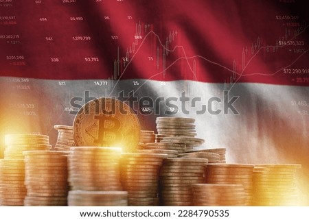 Indonesia flag and big amount of golden bitcoin coins and trading platform chart. Crypto currency concept Royalty-Free Stock Photo #2284790535