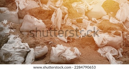 Texture of broken barricade wall made of white sandbags for war purposes. Defense concept background bags to strengthen the defensive structure during the battle. Royalty-Free Stock Photo #2284790653