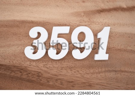 White number 3591 on a brown and light brown wooden background.