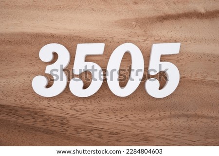 White number 3505 on a brown and light brown wooden background.